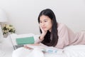 Asian woman using the laptop on the bed,Teenagers use computers in their homes Royalty Free Stock Photo