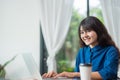 Asian woman using on laptop computer near window at cafe restaurant,Digital age lifestyle,using Technolgy concept,co working spa