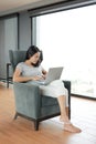 Asian woman using laptop computer working online at home. People during the introvert time at home from the epidemic Royalty Free Stock Photo