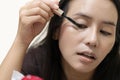 A asian woman is using mascara Royalty Free Stock Photo