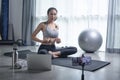 Asian woman using phone camera for live streaming teach yoga online in living room Royalty Free Stock Photo