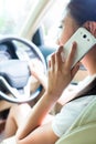 Asian woman using phone driving car Royalty Free Stock Photo