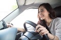 Asian woman using phone and sending a message during driving a car Royalty Free Stock Photo