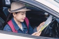 Asian woman using smartphone and map between driving car on road trip Royalty Free Stock Photo
