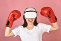 Asian woman using vr glasses, Working out with punch boxing video games application from virtual reality headset Royalty Free Stock Photo