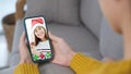 Asian woman video call for greeting in Christmas celebration, Woman hand holding smart phone while talking with friend in