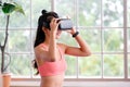 Asian woman virtual reality headset while exercise at home, Healthy asia girl wearing vr glasses for interactive exercise, e sport Royalty Free Stock Photo