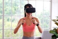 Asian woman virtual reality headset while exercise at home, Healthy asia girl wearing vr glasses for interactive exercise, e sport