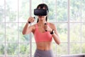 Asian woman virtual reality headset while exercise at home, Healthy asia girl wearing vr glasses for interactive exercise, e sport