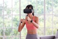 Asian woman virtual reality headset while exercise at home, Healthy asia girl wearing vr glasses for interactive exercise, e sport