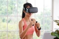 Asian woman virtual reality headset while exercise at home, Healthy asia girl wearing vr glasses for interactive exercise, e sport Royalty Free Stock Photo