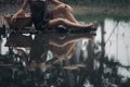 asian woman waering salong sitting on wooden bridge washing clothes in the river Royalty Free Stock Photo