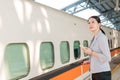 Asian woman waiting for her train arrival