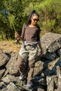 An asian women walking along a rocky river back while fly fishing in the summer Royalty Free Stock Photo