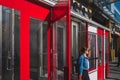 Asian woman walking out of the doors of New World Mall in Flushing Chinatown