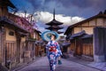 Asian woman walking Yasaka in street near Pagoda in Kyoto, Japan Royalty Free Stock Photo