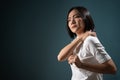 Asian woman was sick with body pain office syndrome and standing isolated over blue background. Royalty Free Stock Photo