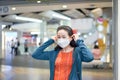 Asian Woman was wearing and putting white face mask on her face in shopping mall Royalty Free Stock Photo