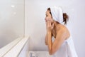 Asian Woman wash her face in the bathroom after shower Royalty Free Stock Photo