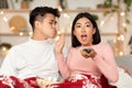 Asian Woman Watching Movie Refusing To Kiss Boyfriend At Home Royalty Free Stock Photo