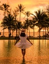 sunset at a tropical swimming pool with palm trees at the island of Koh Kood Thailand Royalty Free Stock Photo