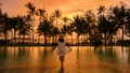 sunset at a tropical swimming pool with palm trees at the island of Koh Kood Thailand Royalty Free Stock Photo