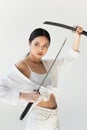 Asian woman with weapon looking away
