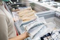 Asian woman wear face mask,choosing packed frozen cut fish in freezer in food department of supermarket,people panic buying,