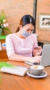 Asian woman wear face mask and online shopping. Social distancing Royalty Free Stock Photo