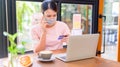 Asian woman wear face mask and online shopping. Social distancing Royalty Free Stock Photo
