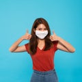 Asian woman wear face mask, thumbs up. Covid-19 coronavirus prevention, health safety, or healthy people lifestyle Royalty Free Stock Photo