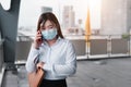 An Asian woman Wear a mask in the subway is talking on the phone, waiting for the train, traveling concept by railcar, businessman Royalty Free Stock Photo