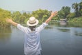 Asian woman wear weave hat and white shirt with standing on wooden terrace, Royalty Free Stock Photo