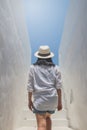 Asian woman wear white shirt and weave hat walking up on concrete stairs. Royalty Free Stock Photo