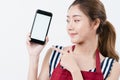 Asian woman wearing apron holding a mobile phone and point her finger to while smiling and happy, Concept using mobiles phone