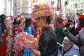 Asian woman wearing bonnet made with Peeps and eggs at the Fifth Avenue Easter Parade.