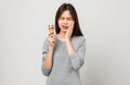 Asian woman wearing braces with sensitive teeth Because eating ice cream that is cold on grey background Royalty Free Stock Photo