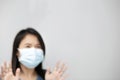 Asian woman wearing facial mask for protection from air pollution or virus epidemic isolated background.