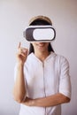 Asian woman wearing glasses virtual reality.in the pose using the 3D world Royalty Free Stock Photo