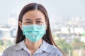 Asian woman wearing hygienic protect face mask to prevent COVID-19 coronavirus infection while outside home during covid virus