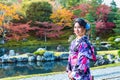 Asian woman wearing japanese traditional kimono in autumn park. Japan