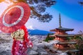 Asian woman wearing japanese traditional kimono at Chureito red  pagoda and Fuji mountain in cherry blossom festival, Japan Royalty Free Stock Photo