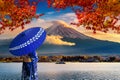 Asian woman wearing japanese traditional kimono at Fuji mountain. Autumn at Kawaguchiko lake in Japan. Royalty Free Stock Photo