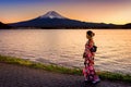 Asian woman wearing japanese traditional kimono at Fuji mountain. Sunset at Kawaguchiko lake in Japan Royalty Free Stock Photo