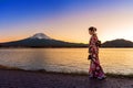 Asian woman wearing japanese traditional kimono at Fuji mountain. Sunset at Kawaguchiko lake in Japan Royalty Free Stock Photo