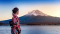 Asian woman wearing japanese traditional kimono at Fuji mountain. Sunset at Kawaguchiko lake in Japan Royalty Free Stock Photo