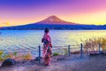 Asian woman wearing japanese traditional kimono at Fuji mountain. Sunset at Kawaguchiko lake in Kyoto, Japan Royalty Free Stock Photo