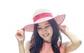 Asian woman wearing pink straw hat with expression of happy