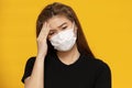 Asian woman wearing protection mask or surgical mask for protected virus and air pollution on yellow background Royalty Free Stock Photo