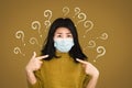 Scared Asian woman wearing protective mask on fear face hand pointing herself with question mark worried about getting sick from